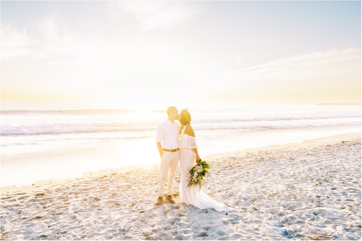 Bride and groom kissing at sunset on San Clemente Beach