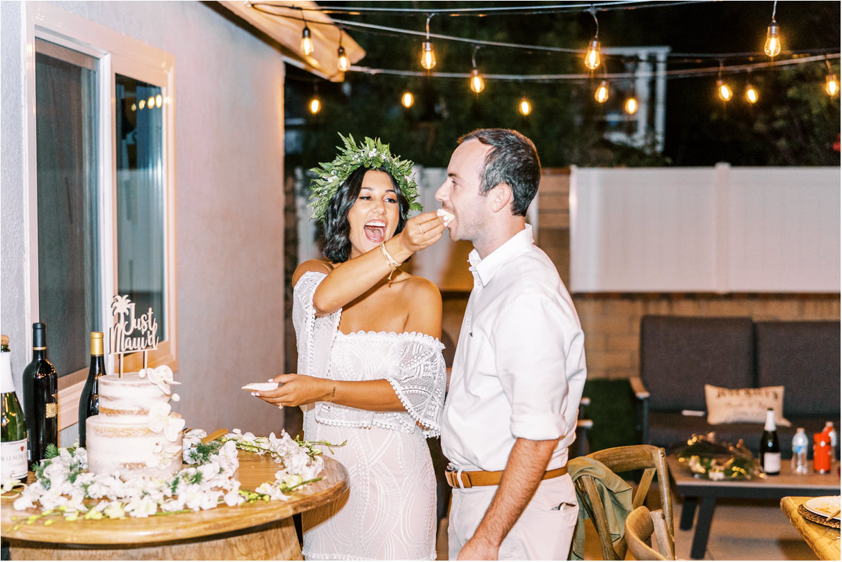 Bride and groom feeding each other wedding cake