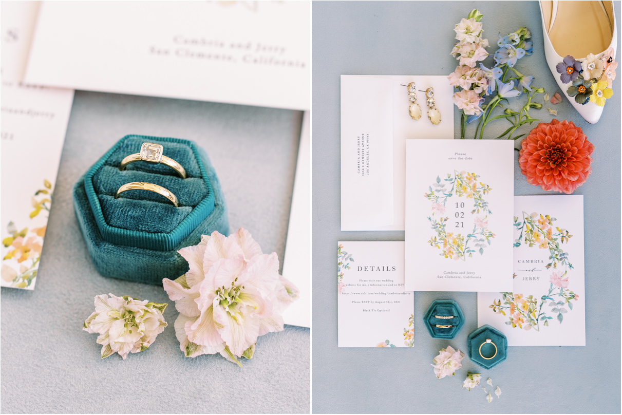 Wedding invitation flatlay and wedding rings with flowers