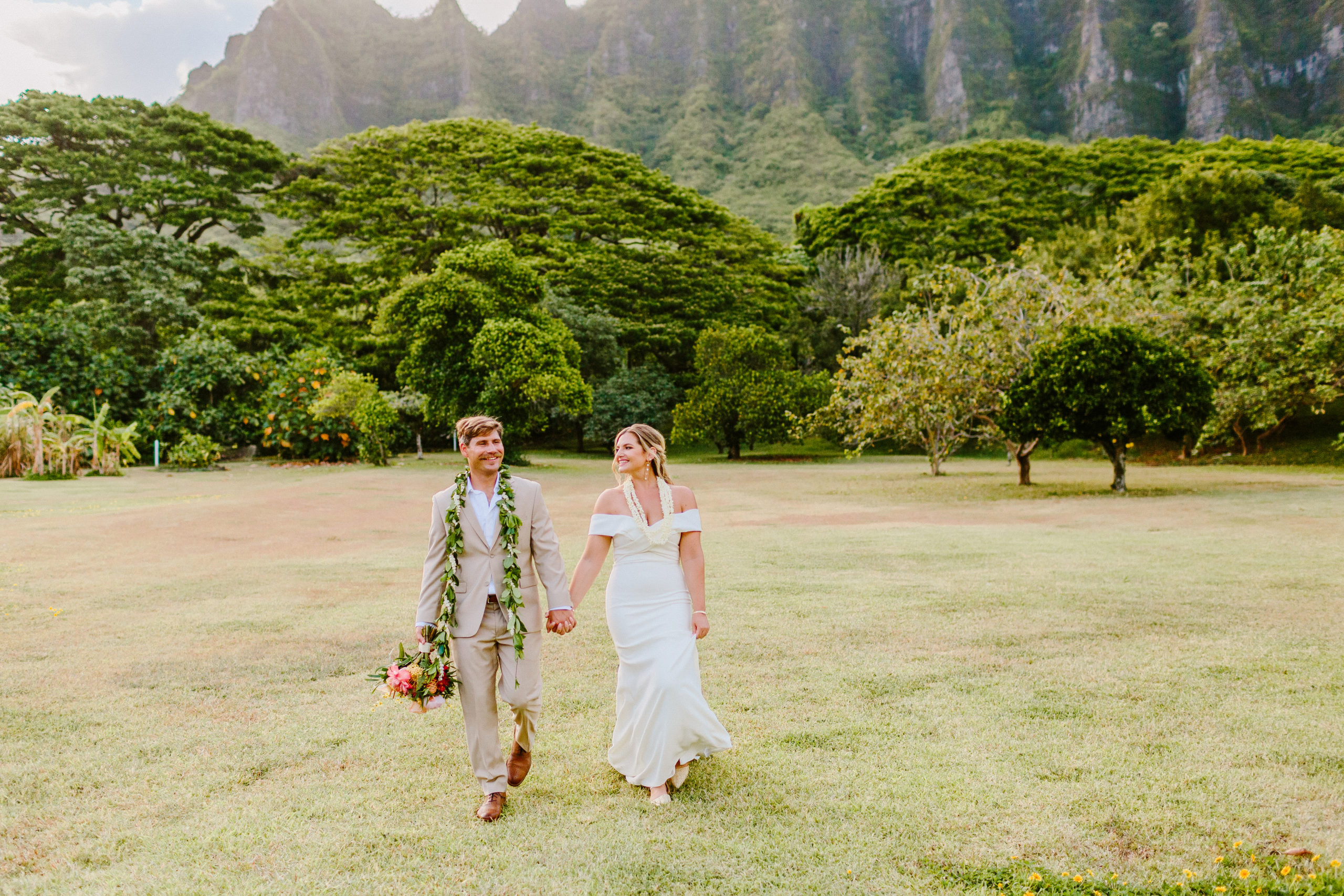 bride and groom holding hands walking