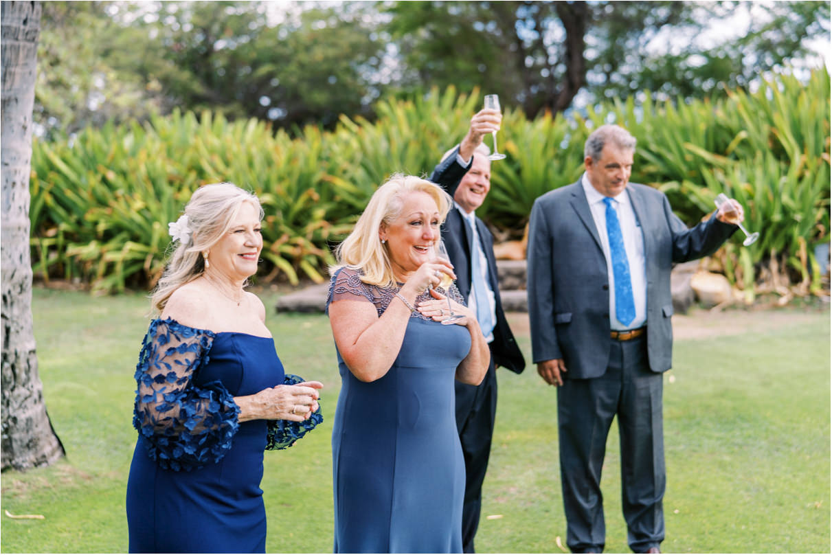 parents of the wedding couple cheering with champagne