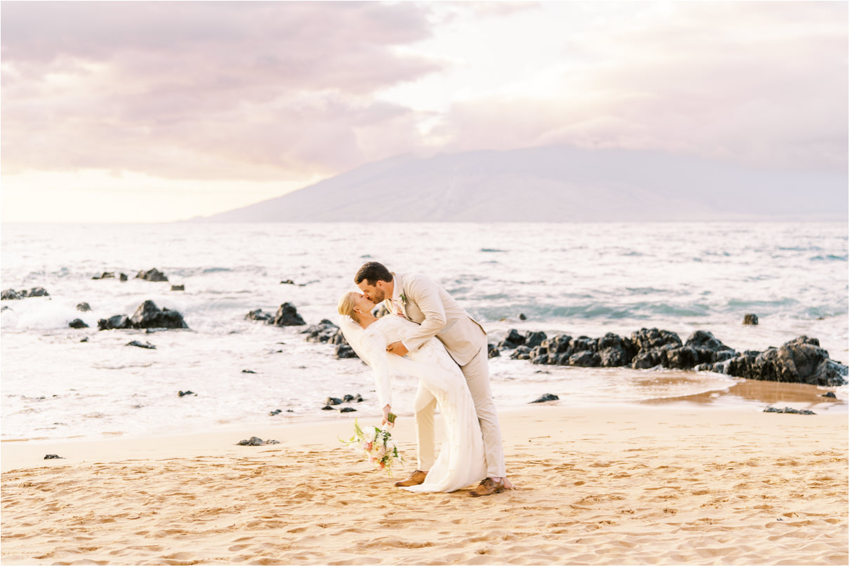 bride and groom passionate kiss on Maui beach
