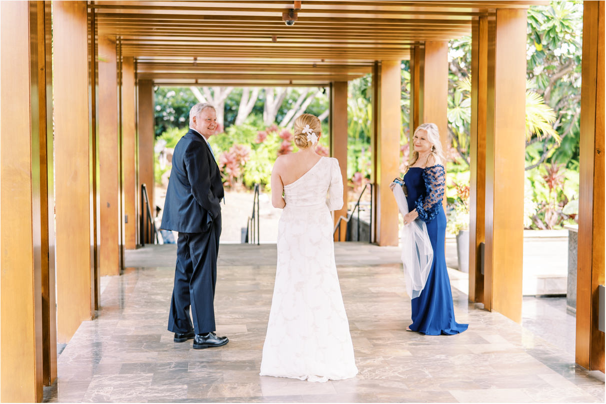 bride with parents walking down corridor