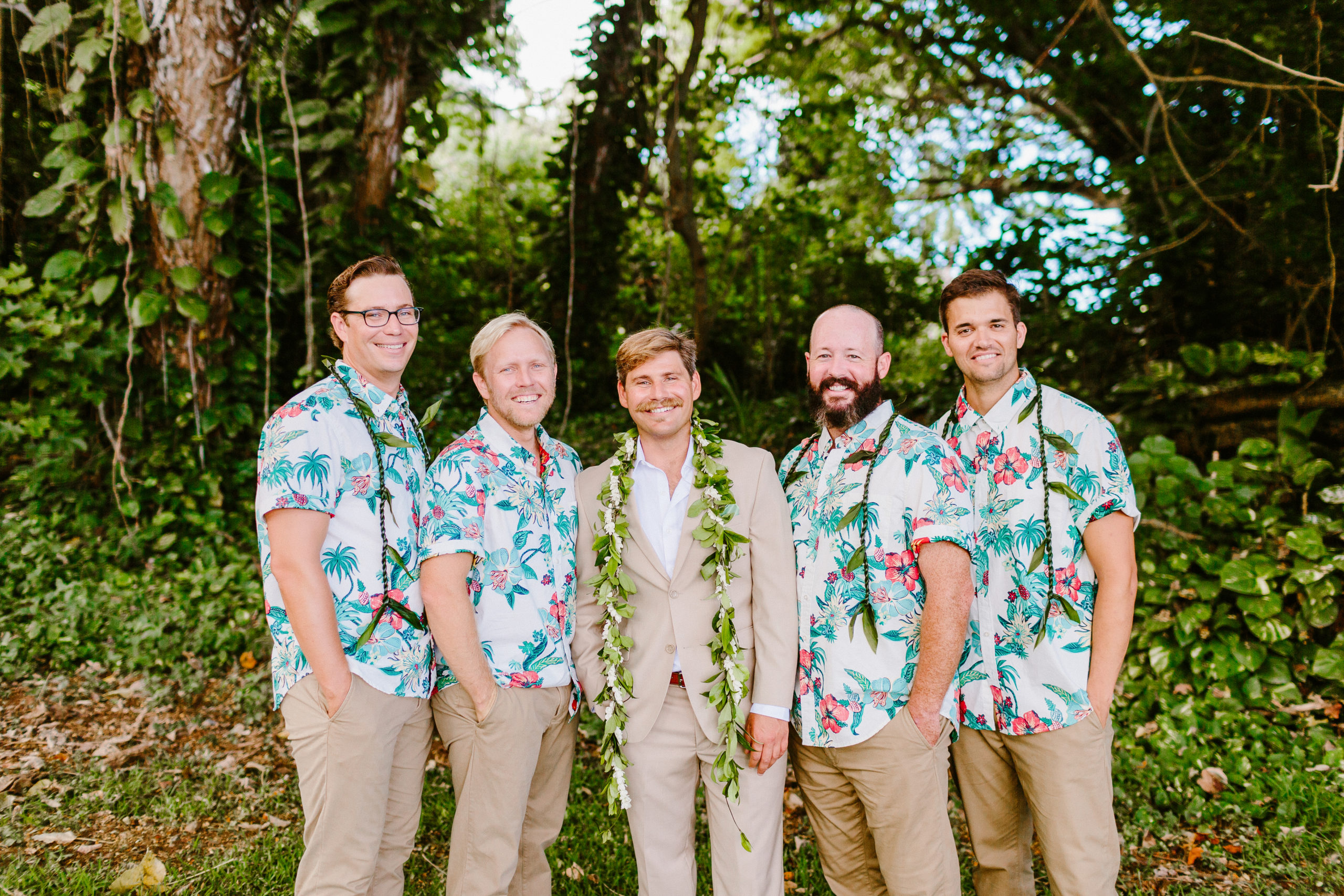 Groomsmen wearing aloha shirts and leis