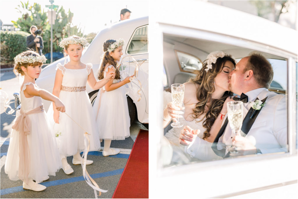 Bride and groom kissing in back of car with champagne