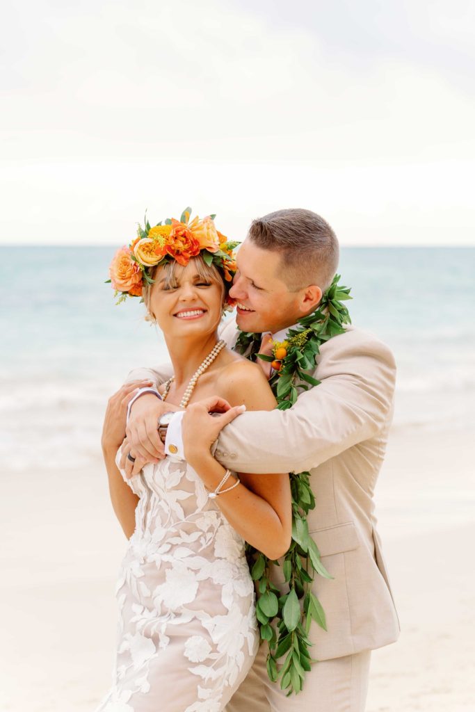 Bride and groom in hawaii wearing lei