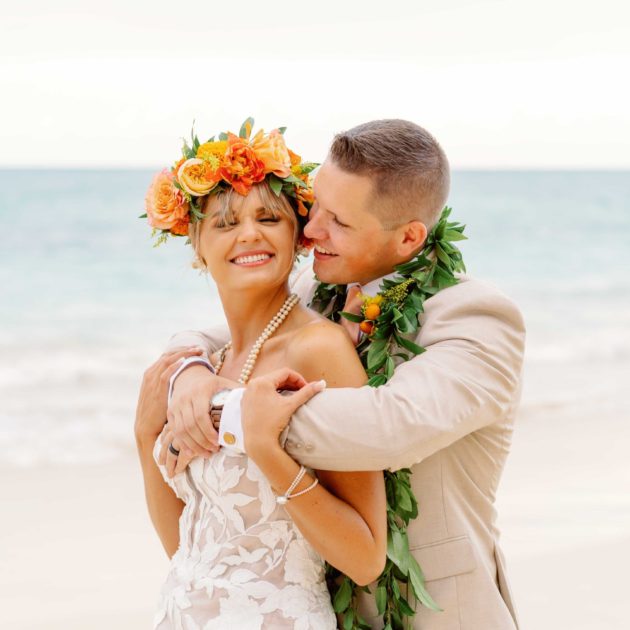 Bride and groom in hawaii wearing lei